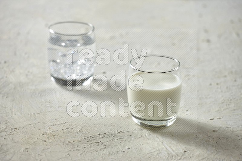 Cold drinks in a glass cup such as water, tamarind, qamar eldin, sobia, milk and hibiscus on textured white background