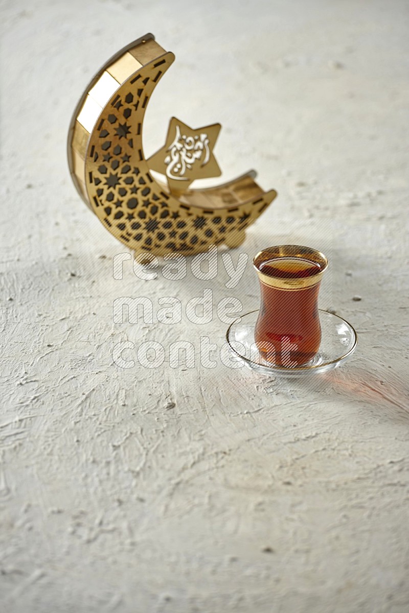 A wooden golden crescent lantern with different drinks, dates, nuts, prayer beads and quran on white background