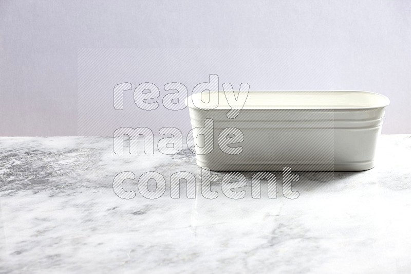 An Empty White Plant Pot on light grey Marble Flooring 45 degree angle