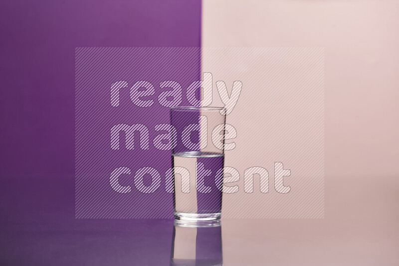 The image features a clear glassware filled with water, set against purple and rose background