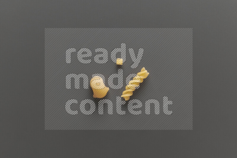 Different pasta types on grey background