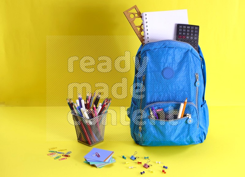 A school bag on yellow background in different angles (back to school)