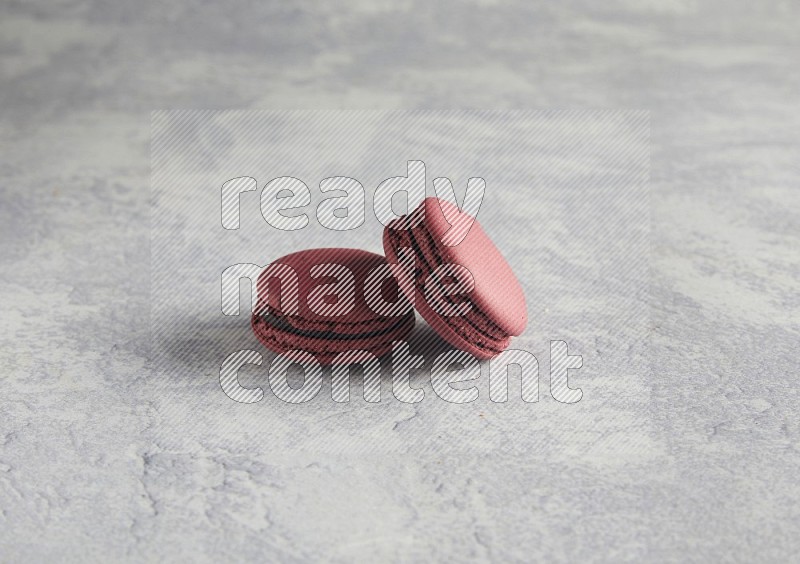 45º Shot of two Red Cherry macarons  on white  marble background