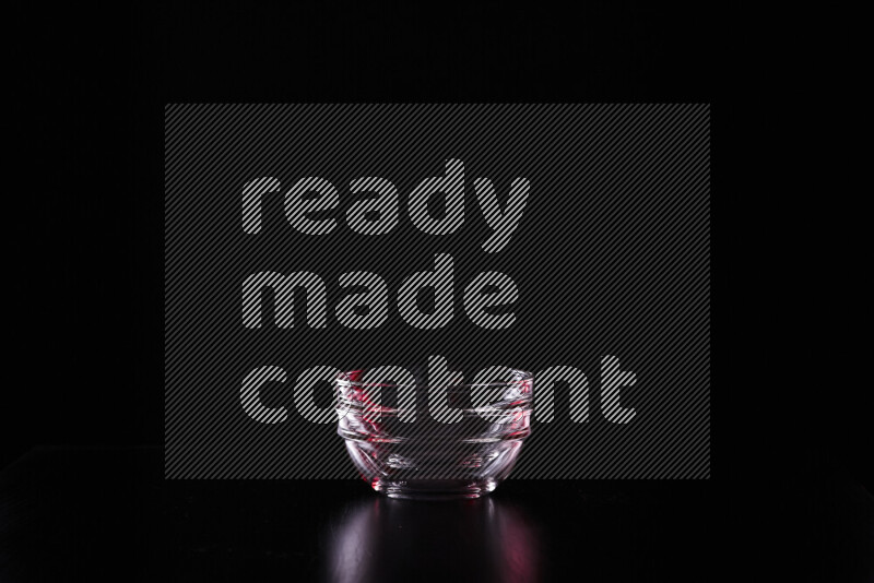 Glassware with rim light in red and white against black background