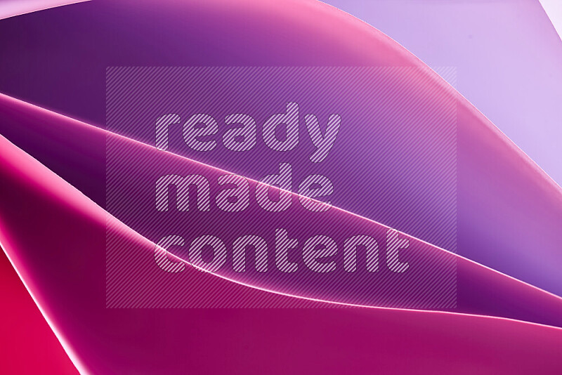 This image showcases an abstract paper art composition with paper curves in purple and pink gradients created by colored light