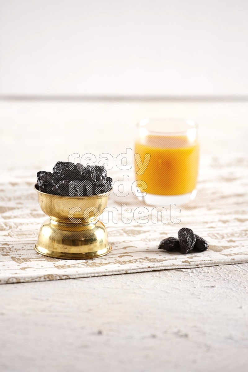 Dried fruits in a metal bowl with qamar eldin in a light setup