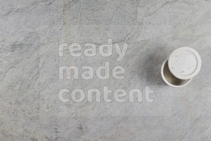 A multicolored pottery Cup on grey marble background