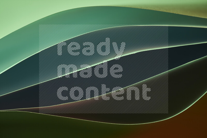 هذه الصورة تعرض تكوين فن الورق التجريدي مع منحنيات ورقية بتدرجات اللون الأخضر والأحمر المكونه بواسطة الضوء الملون