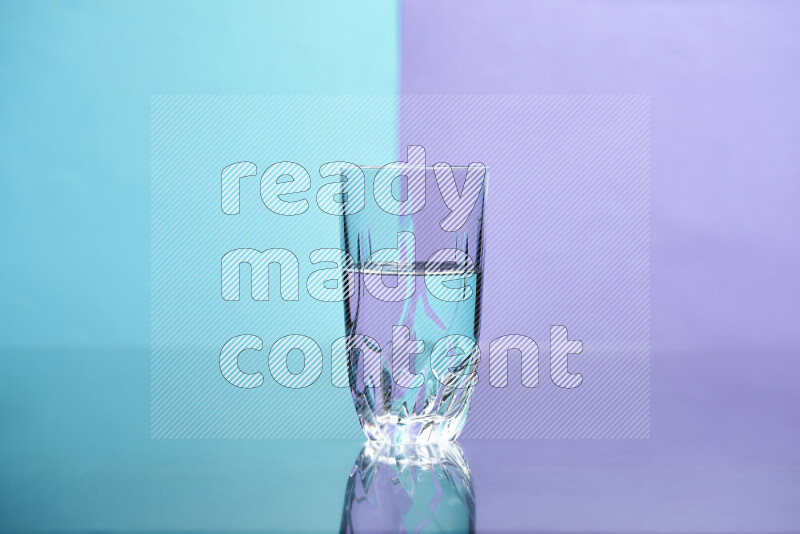 The image features a clear glassware filled with water, set against light blue and light purple background