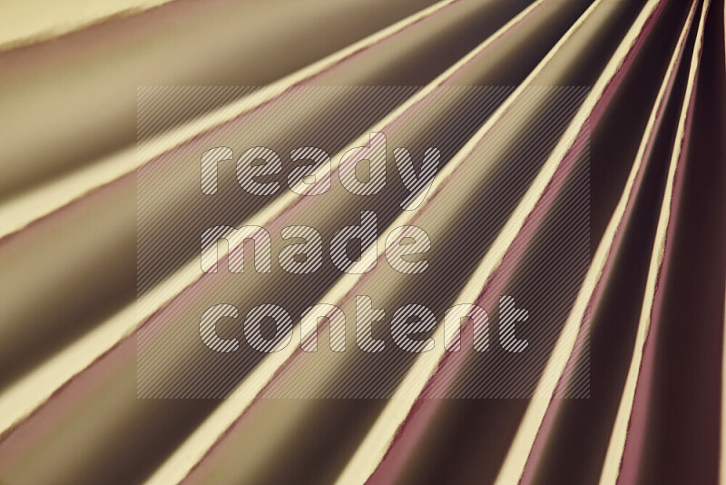 An image presenting an abstract paper pattern of lines in red and gold tones