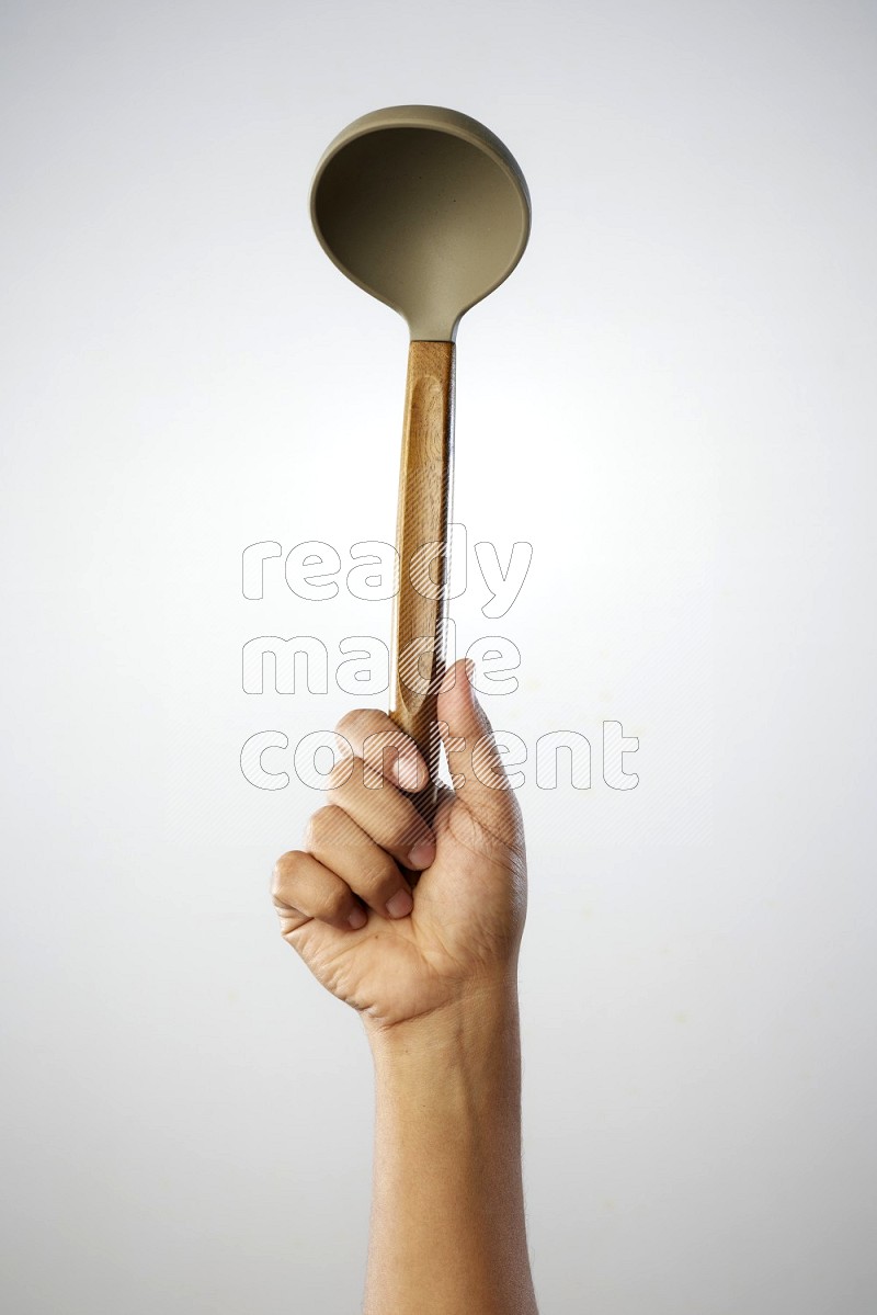 Male Hand Holding ladle on white background