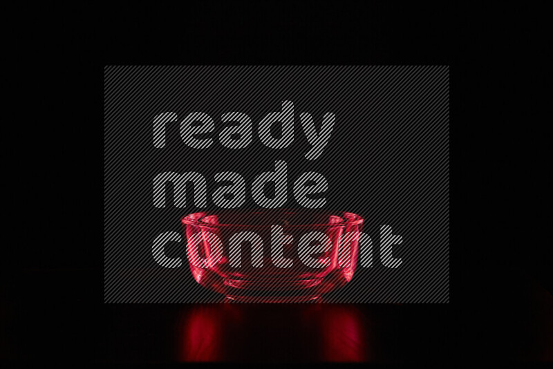 Glassware with rim light in red against black background