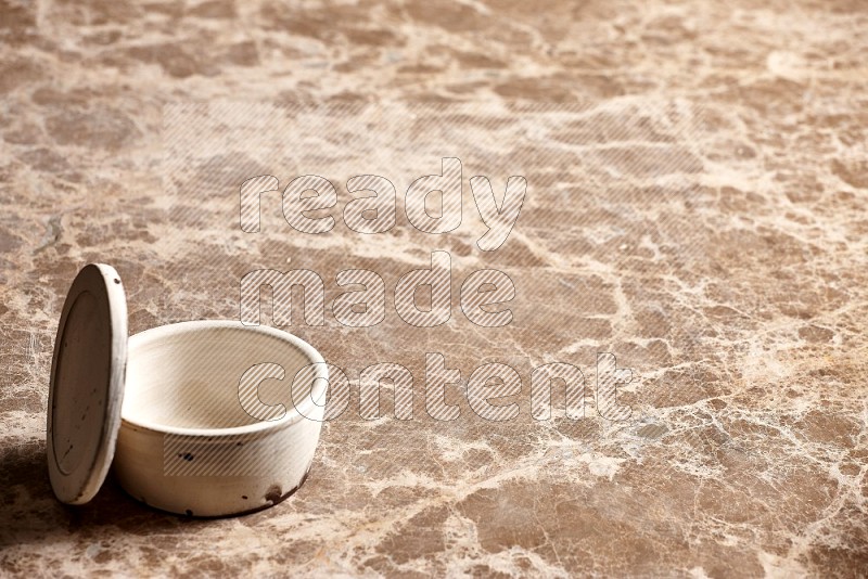 White Pottery Bowl on Beige Marble Flooring, 45 degrees