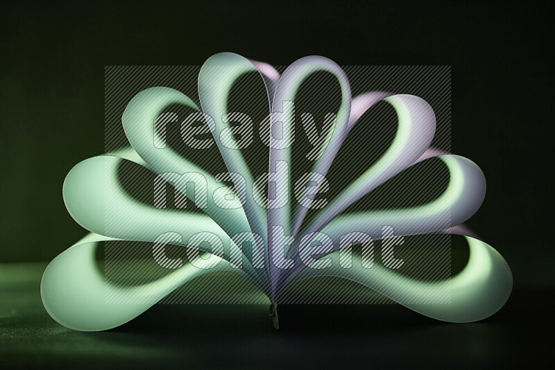 An abstract art piece displaying smooth curves in green and white gradients created by colored light