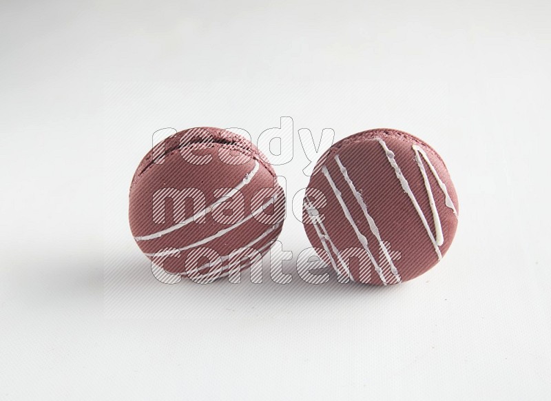 45º Shot of two Red Poppy Flower macarons on white background