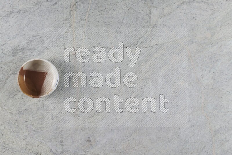 A multicolored pottery Bowl on grey marble background