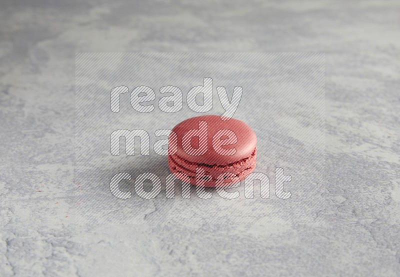 45º Shot of Pink Raspberry macaron on white  marble background
