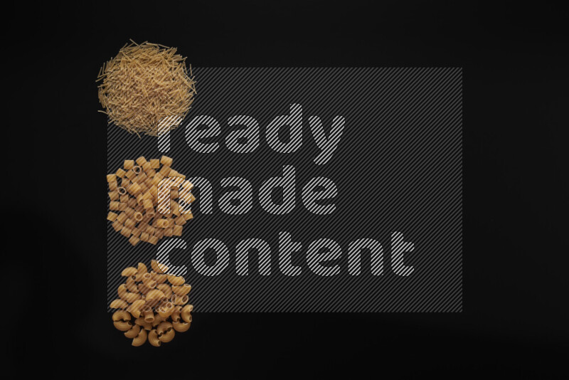 Different pasta types in 3 bunches on black background
