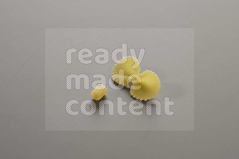 Small rings pasta with other types of pasta on grey background