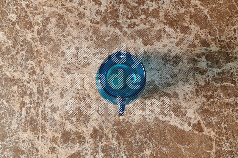Top View Shot Of An Empty Glass Jug On beige Marble Flooring