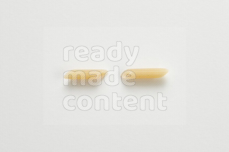 Mini penne pasta on white background
