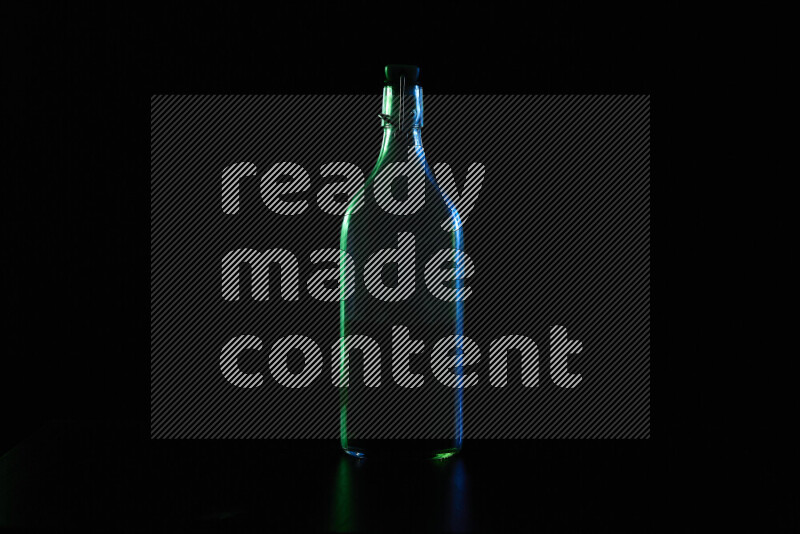 Water bottle with colored rim light against black background