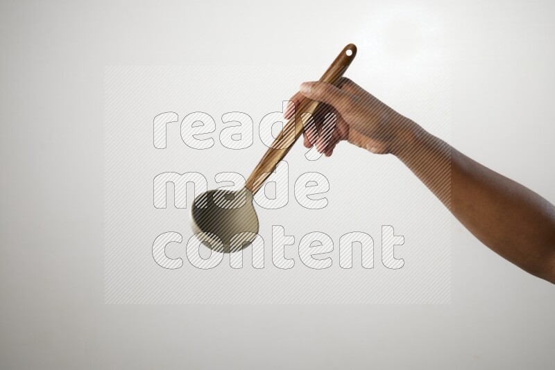 Male Hand Holding ladle on white background