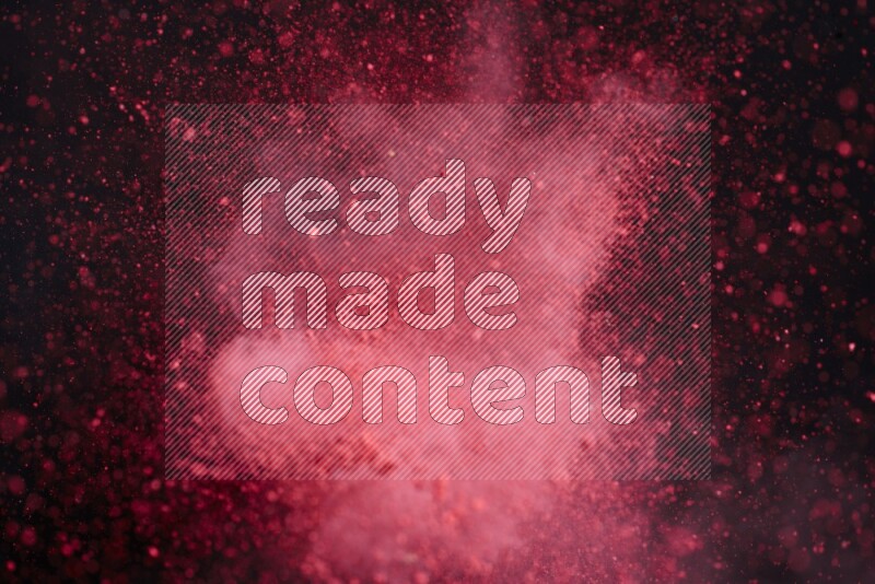 Red powder explosion on black background