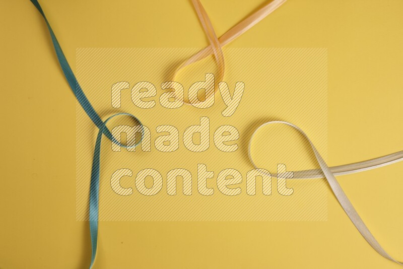 A green collection of sewing and tailoring tools arranged on a yellow background