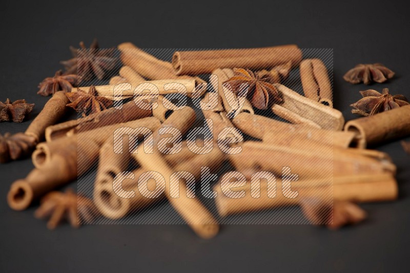 Cinnamon sticks and star anise on black background