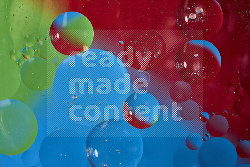 Close-ups of abstract oil bubbles on water surface in shades of blue, red and green