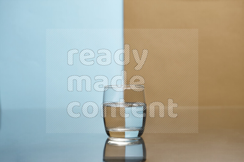 The image features a clear glassware filled with water, set against light blue and beige background