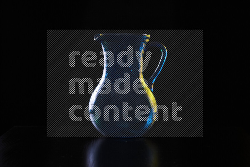 Glassware with rim light in yellow and white against black background