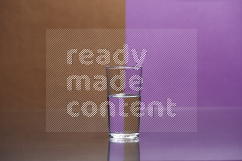 The image features a clear glassware filled with water, set against brown and purple background