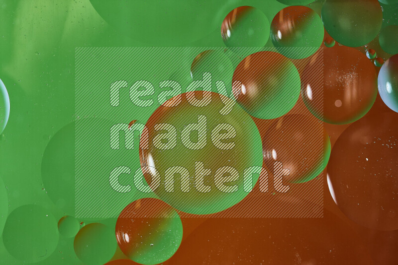 Close-ups of abstract oil bubbles on water surface in shades of green and red