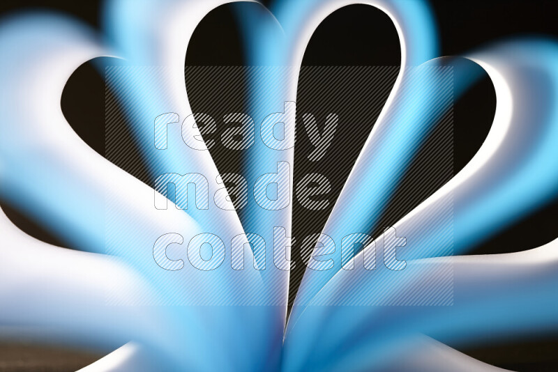 An abstract art piece displaying smooth curves in white and blue gradients created by colored light