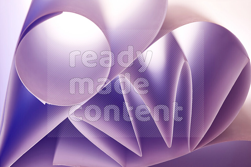 An artistic display of paper folds creating a harmonious blend of geometric shapes, highlighted by soft lighting in purple tones