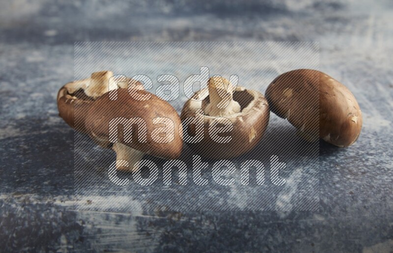 45 degre cremini  mushrooms on a textured rustic blue background