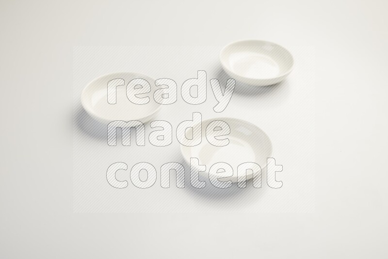 white ceramic round sauce dish on white countertop