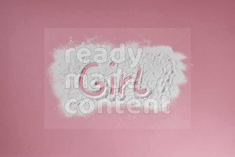 A word written with powder on pink background