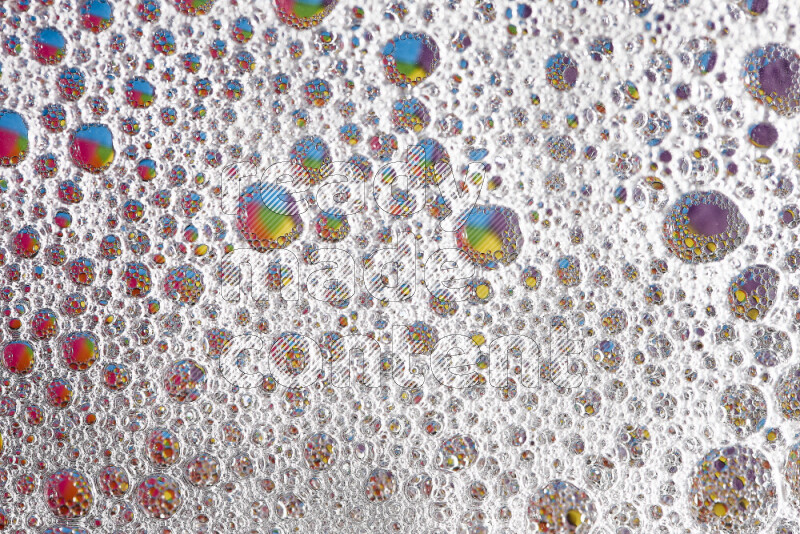 Close-ups of abstract soap bubbles and water droplets on multicolored background