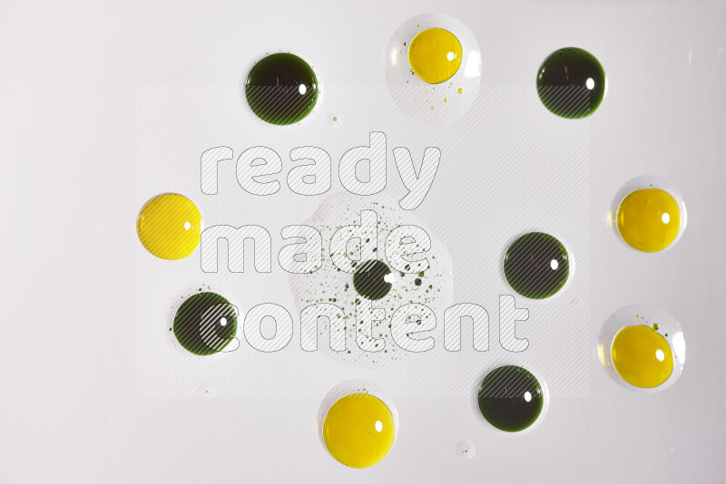 Close-ups of abstract yellow and green paint droplets on the surface