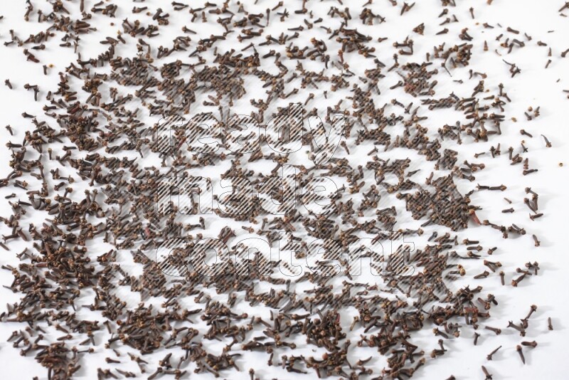 Cloves spread on white flooring