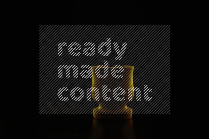 Wooden kitchen essentials with colored rim light against black background