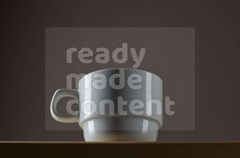 Low angle shot of a white cup on grey background