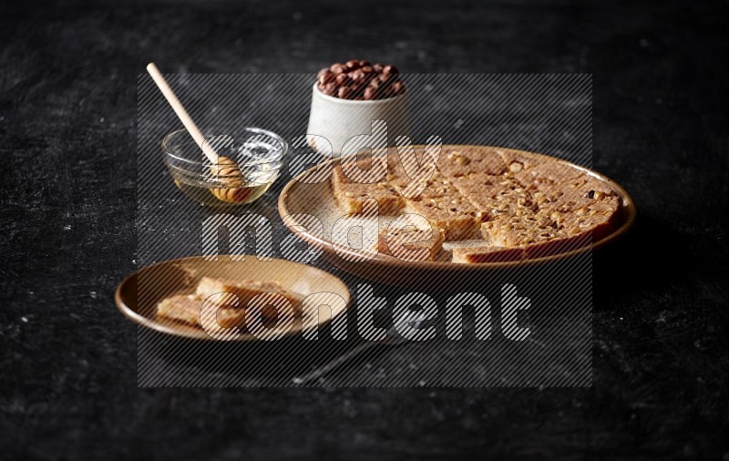 Basbousa with nuts and honey in a dark setup