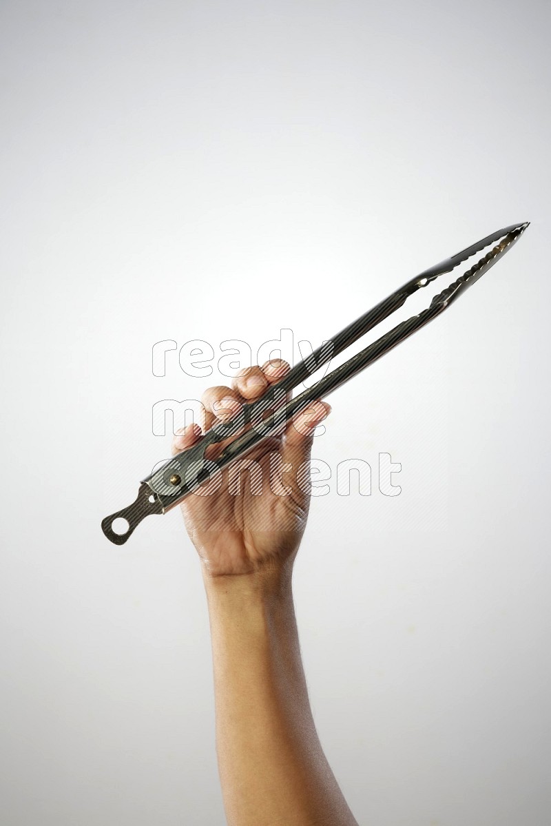 Male Hand Holding Tongs on white background