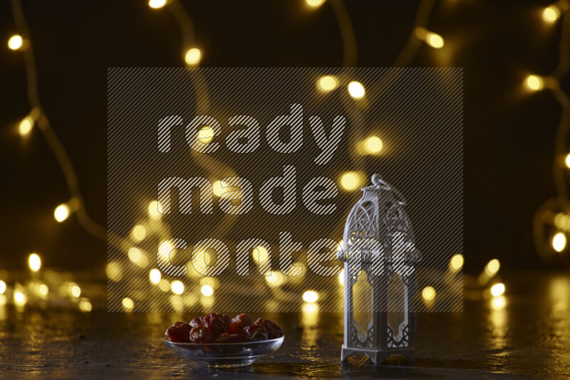 A traditional ramadan lantern surrounded by glowing fairy lights in a dark setup