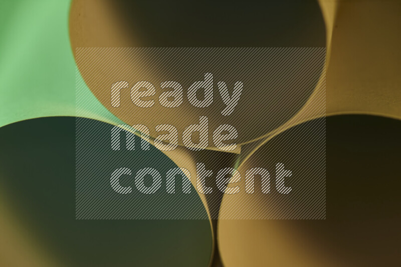 The image shows an abstract paper art with circular shapes in varying shades of green and warm tones