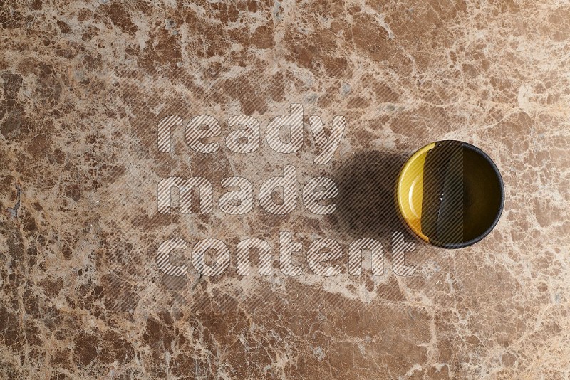 Top View Shot Of A Multicolored Pottery bowl On beige Marble Flooring